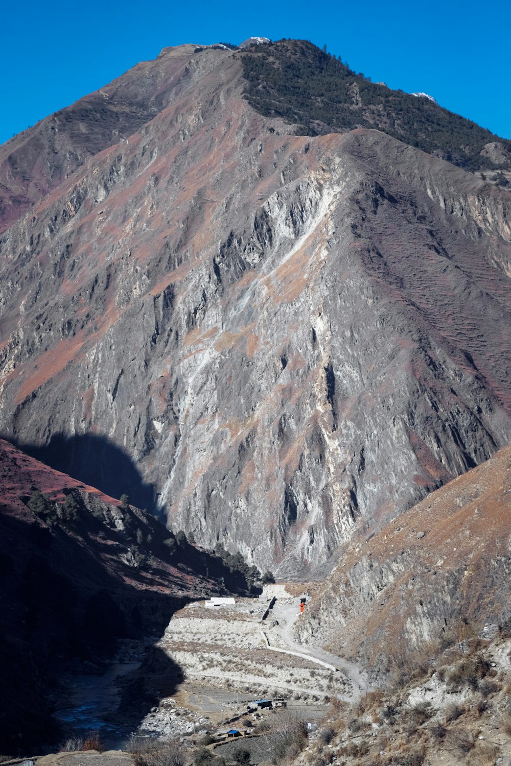 a view of a mountain with a river running through it