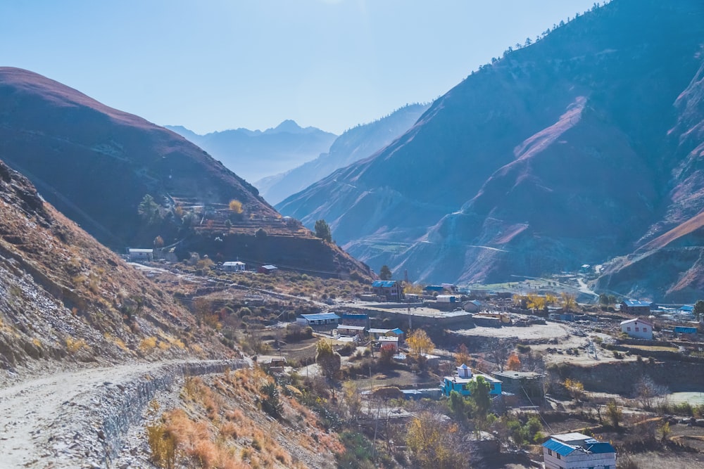 a scenic view of a valley with a mountain in the background