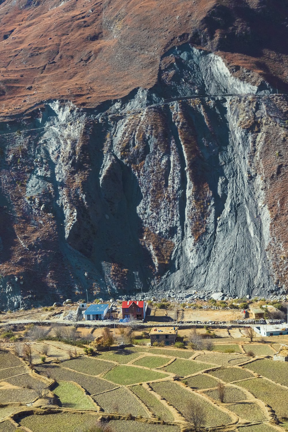 a view of a mountain with a small village in the foreground