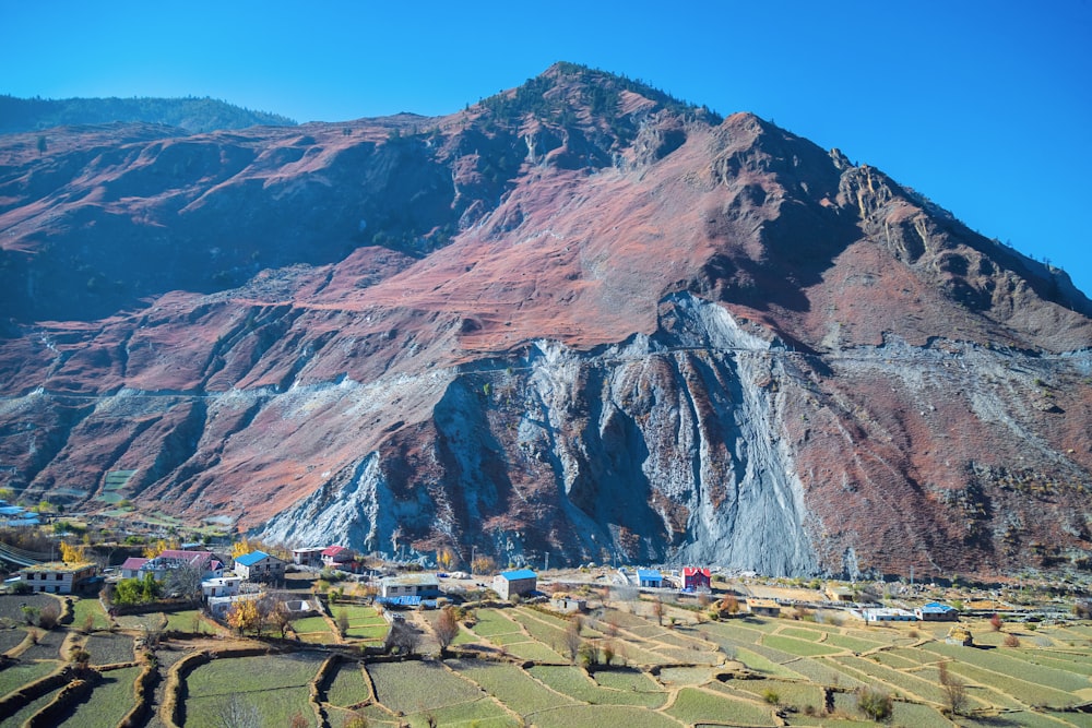 a mountain with a village in the foreground