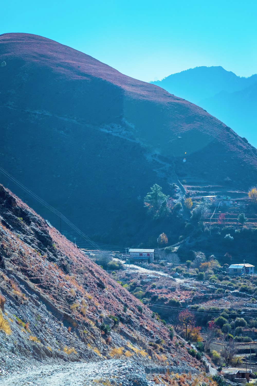 a view of a mountain with a small village in the distance