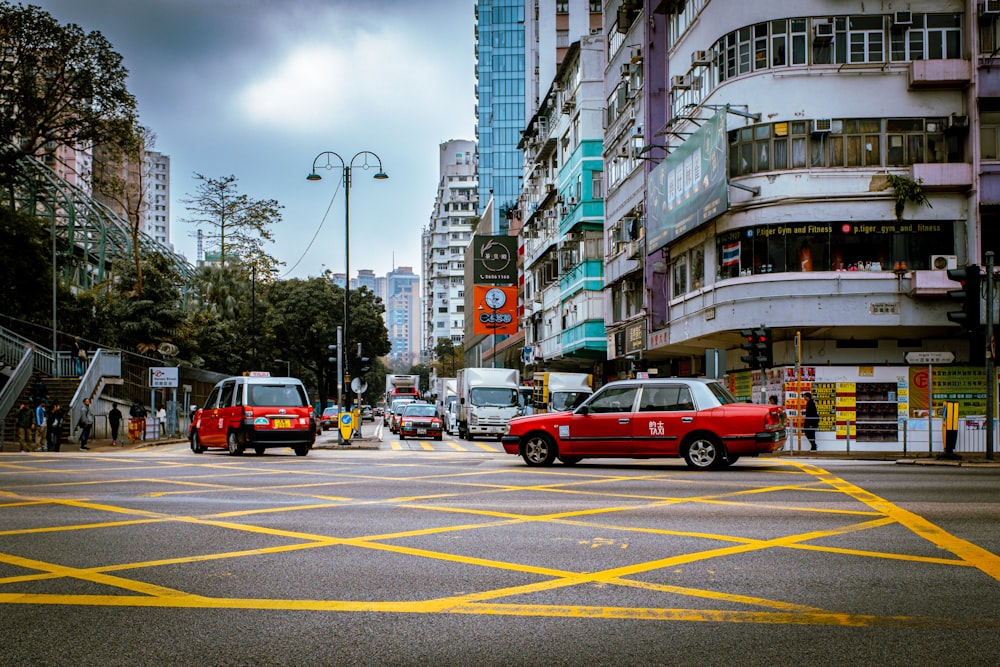 a city street filled with traffic next to tall buildings