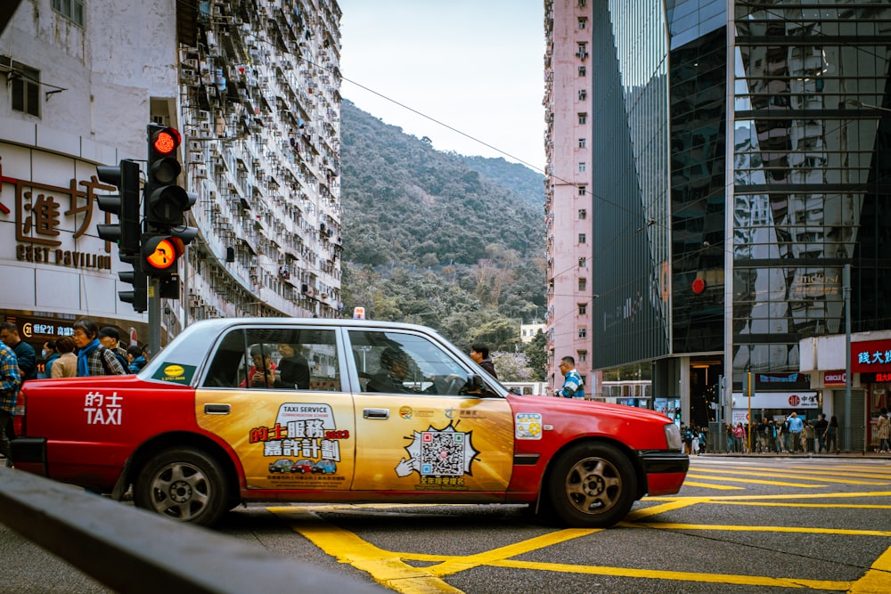 a taxi cab with a hello kitty sticker on the side of it