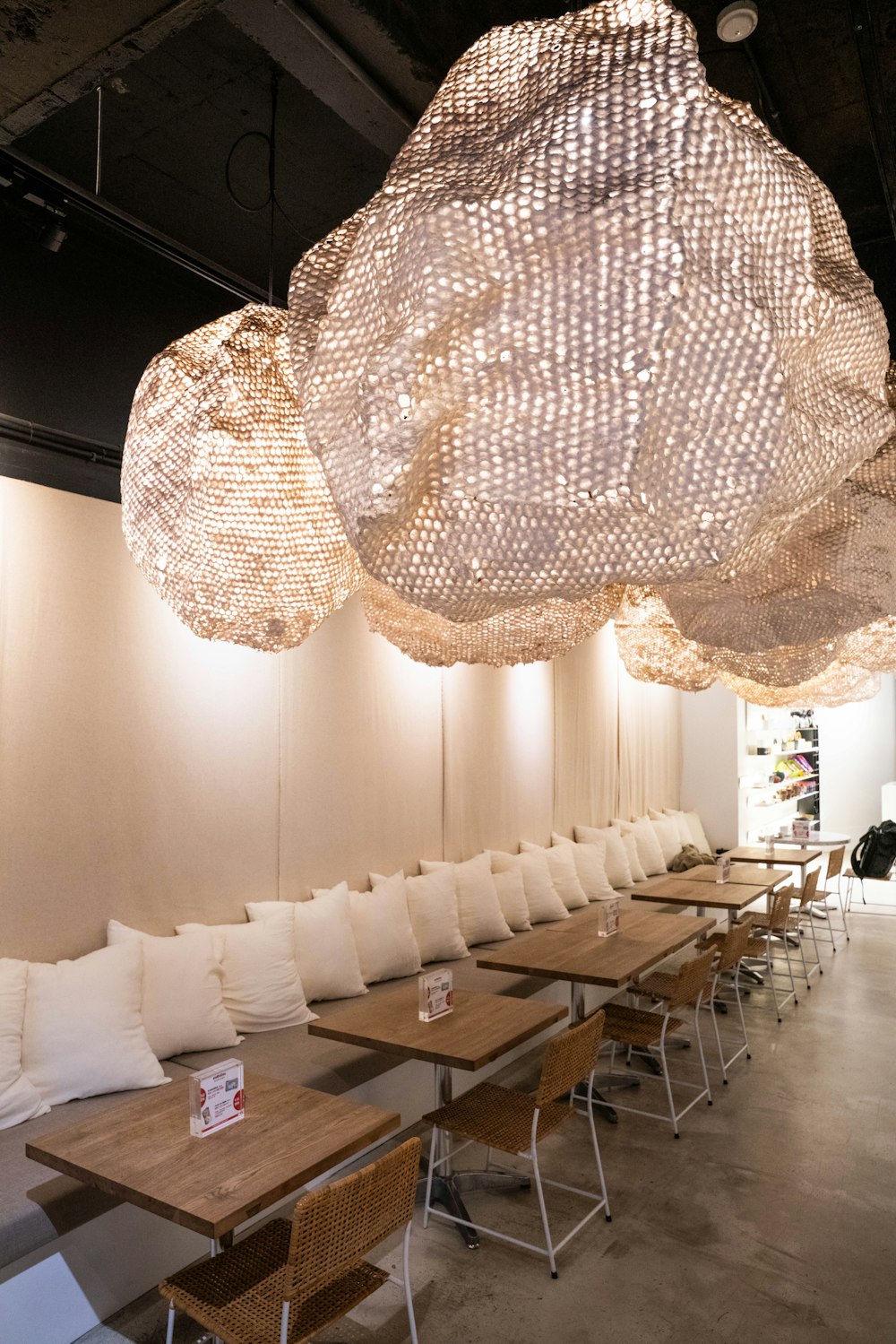 a room filled with lots of wooden tables and chairs