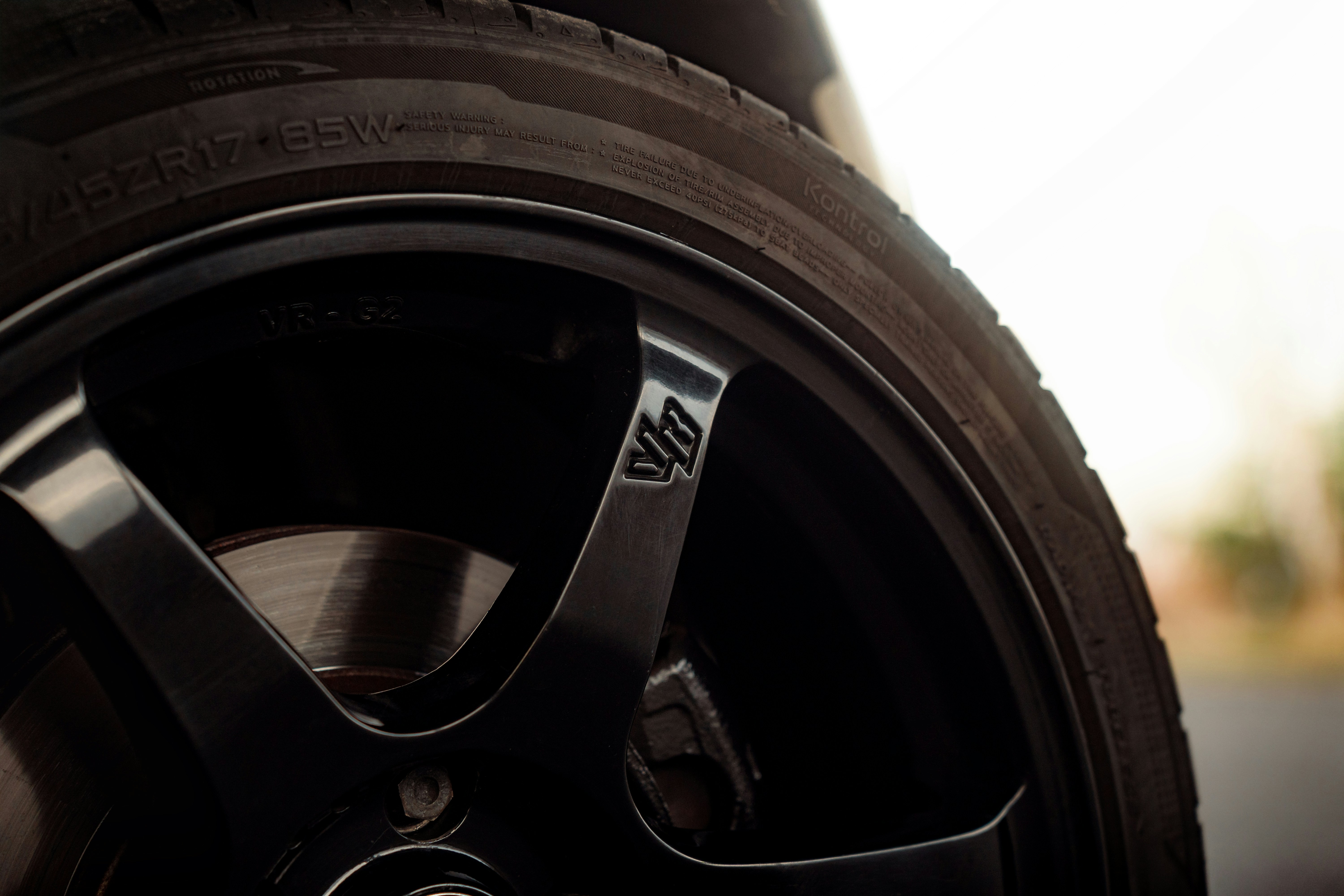 Closeup of electric vehicle tire tread showing wide grooves and stiff blocks