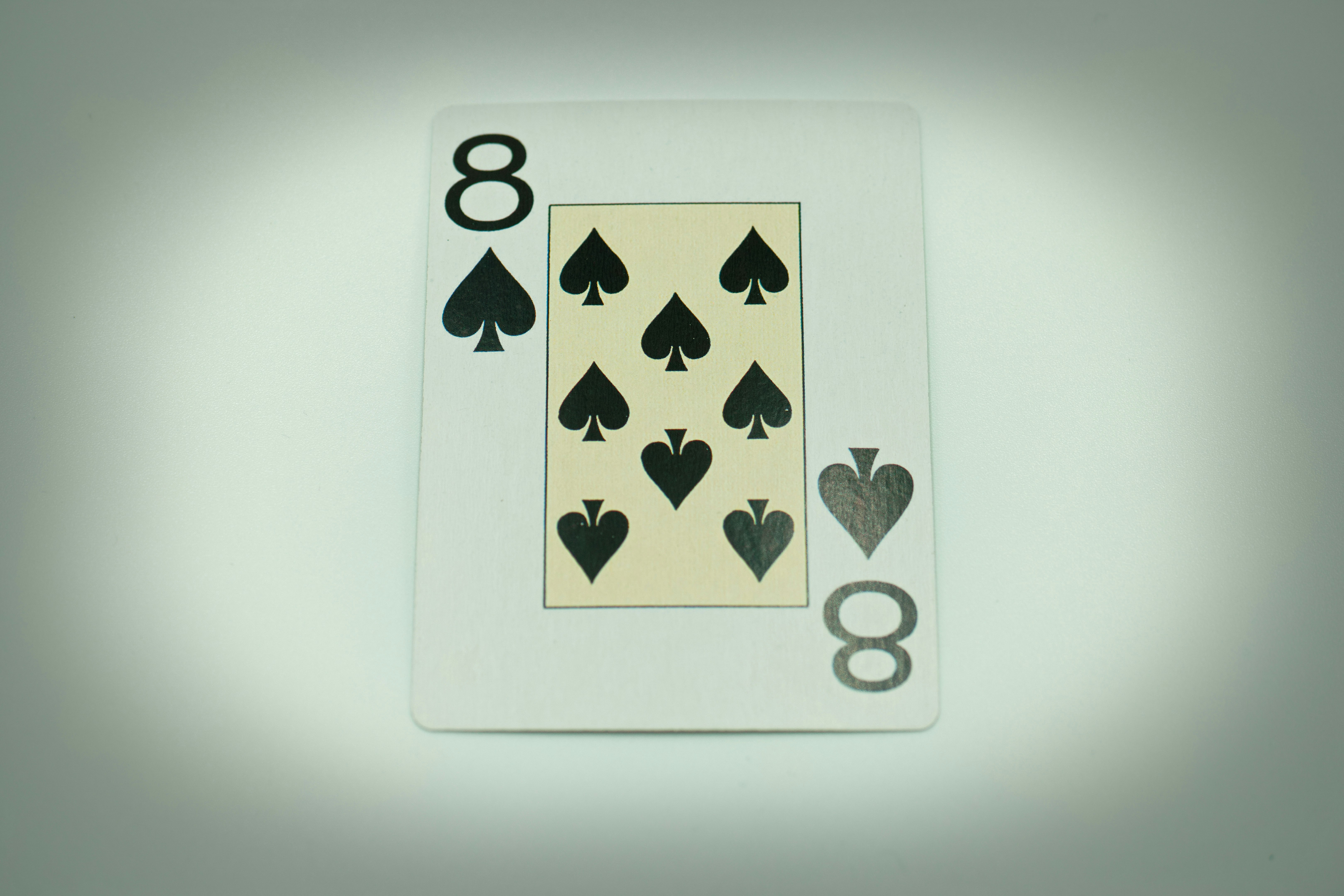 a playing card with eight of spades and eight of hearts