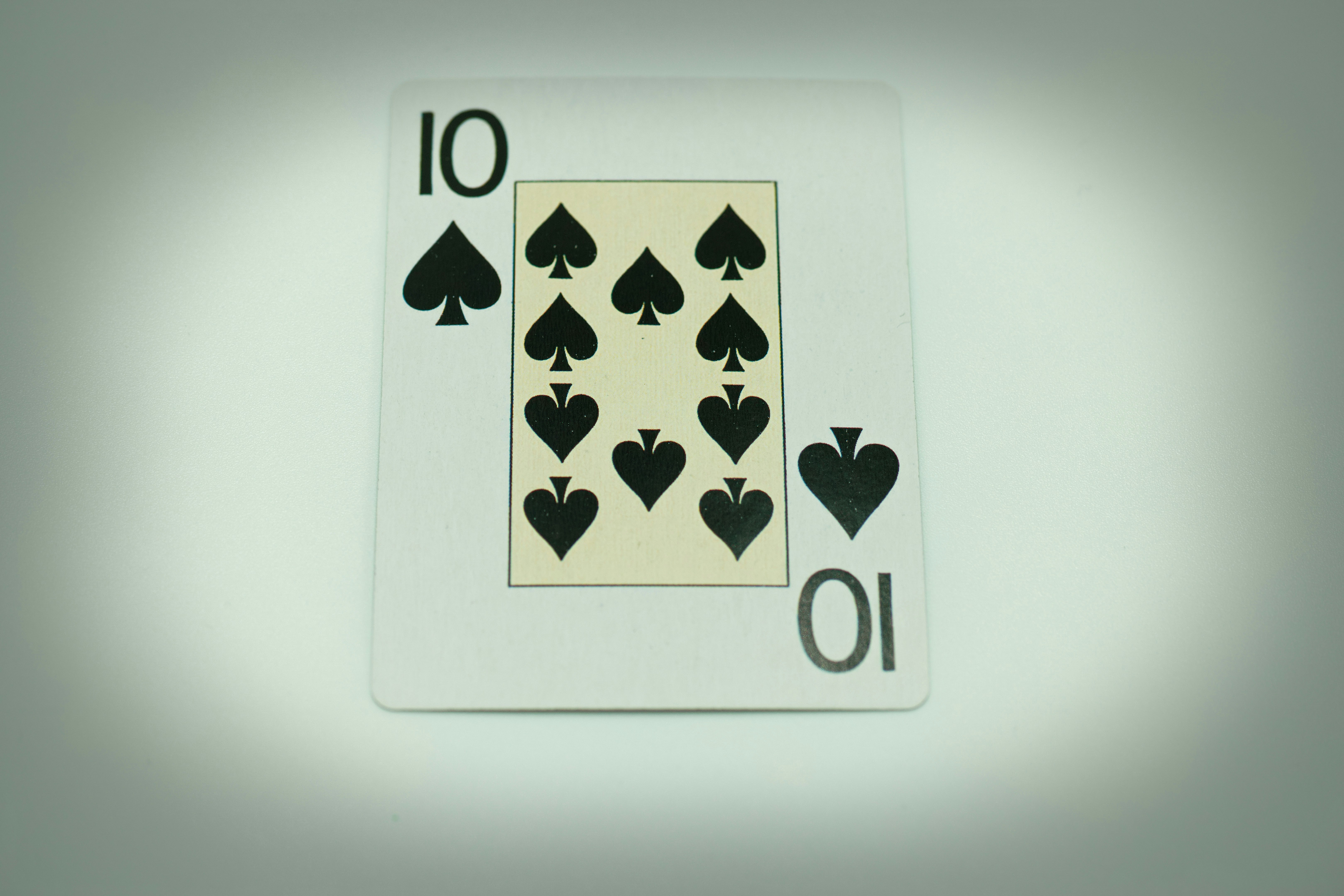 a white playing card with black playing cards