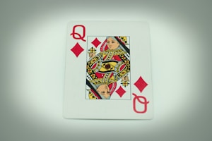 a playing card with a queen of hearts on it