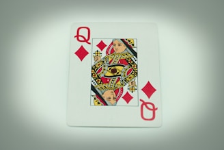 a playing card with a queen of hearts on it