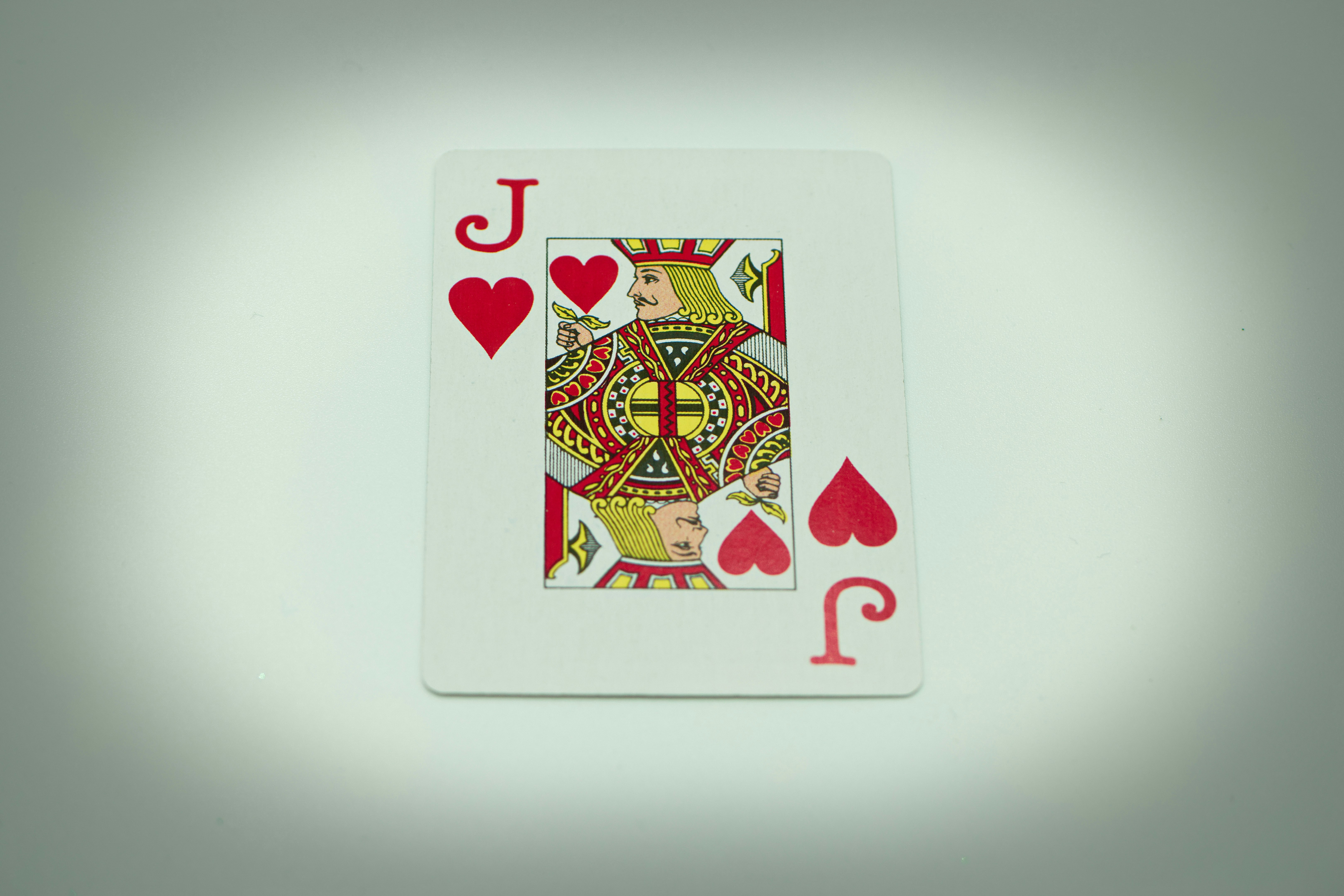 a playing card with a queen of hearts on it