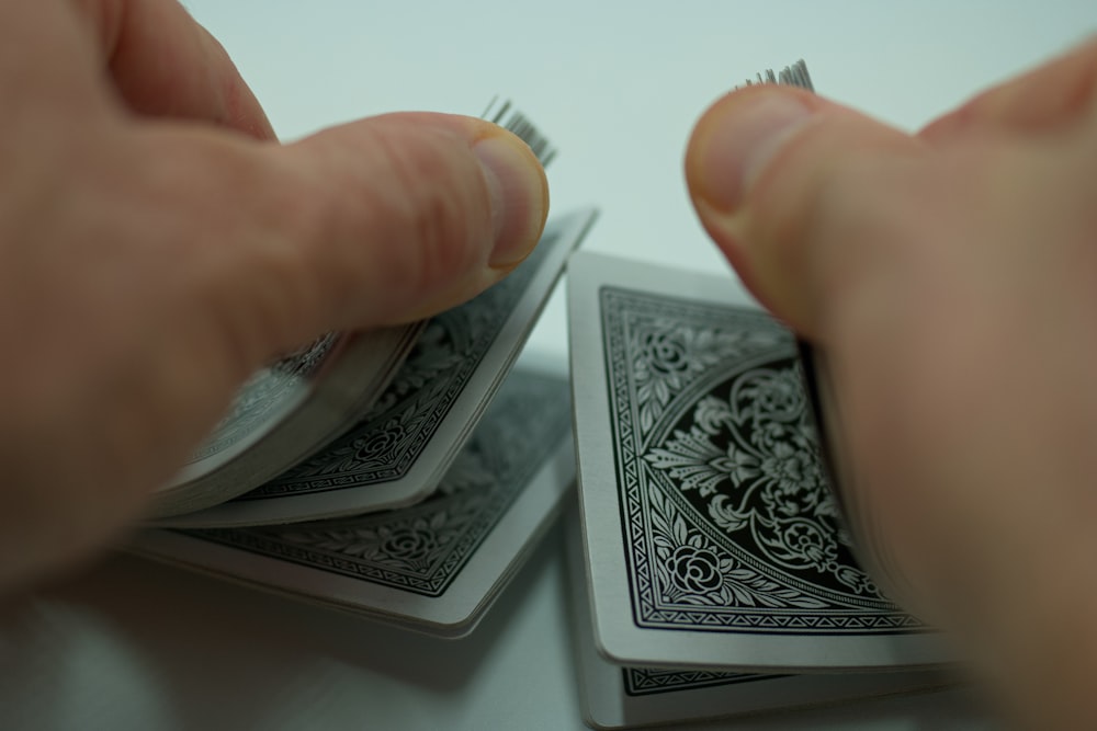 a person holding a piece of playing cards