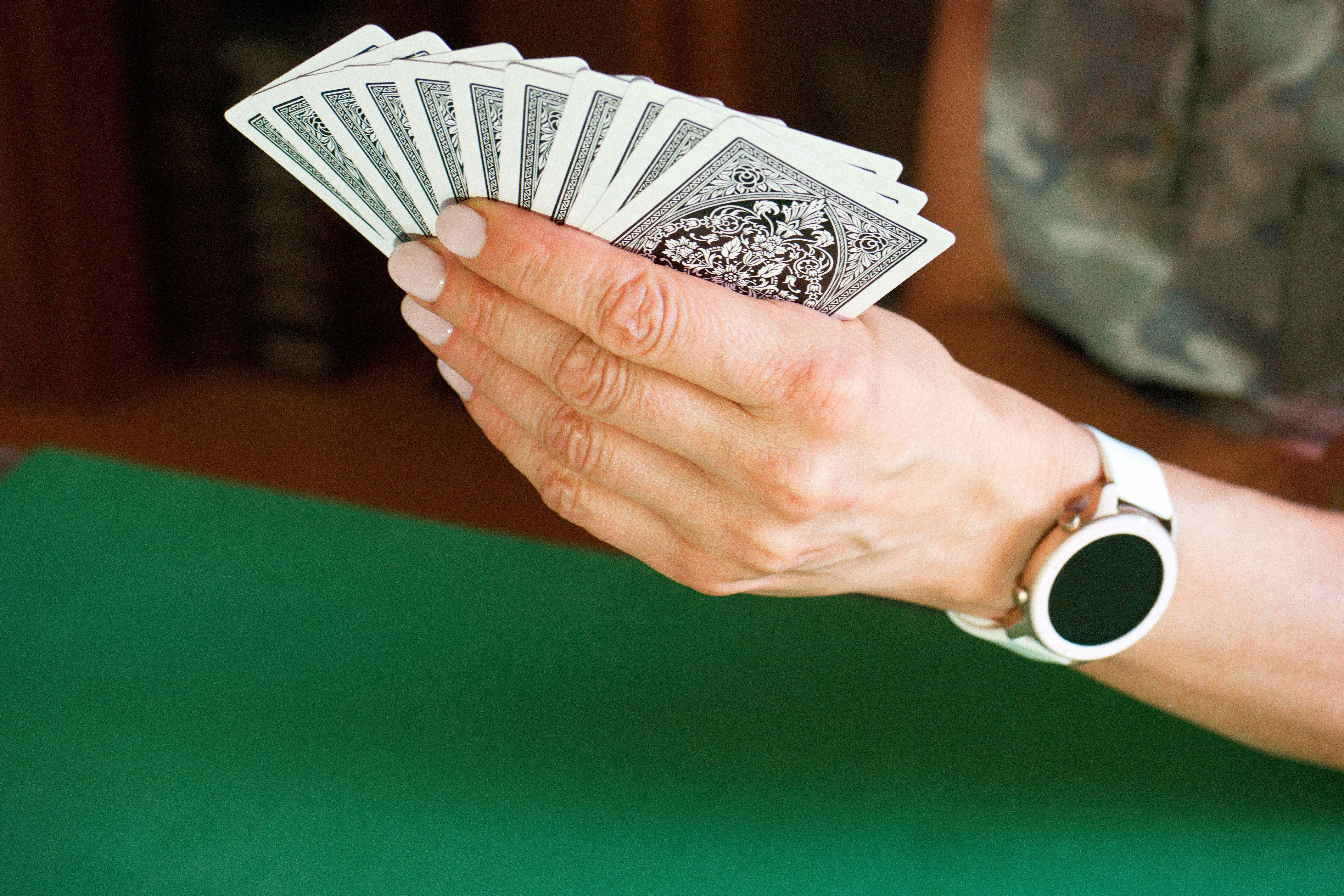 a person holding a stack of playing cards
