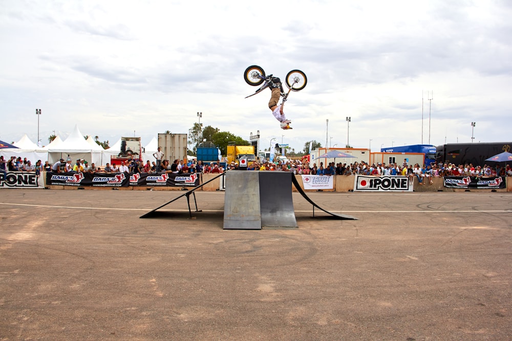 a man flying through the air while riding a bike