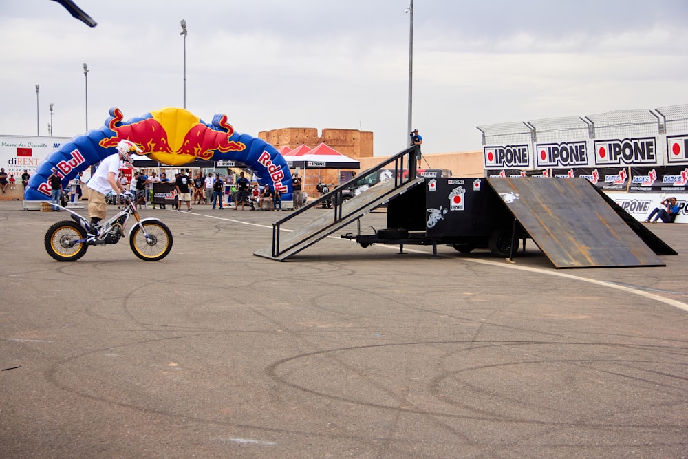 a man riding a bike next to a ramp