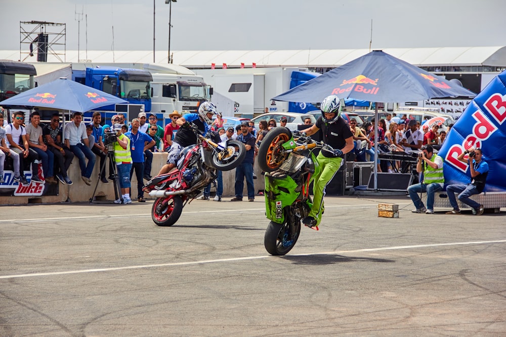 a couple of people on motorcycles in a parking lot