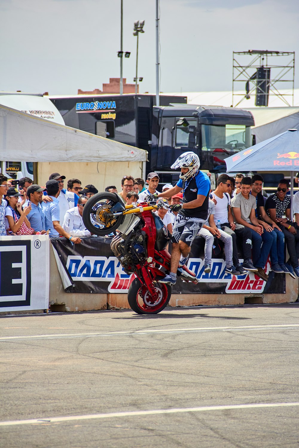 a man riding a motorcycle on top of a ramp