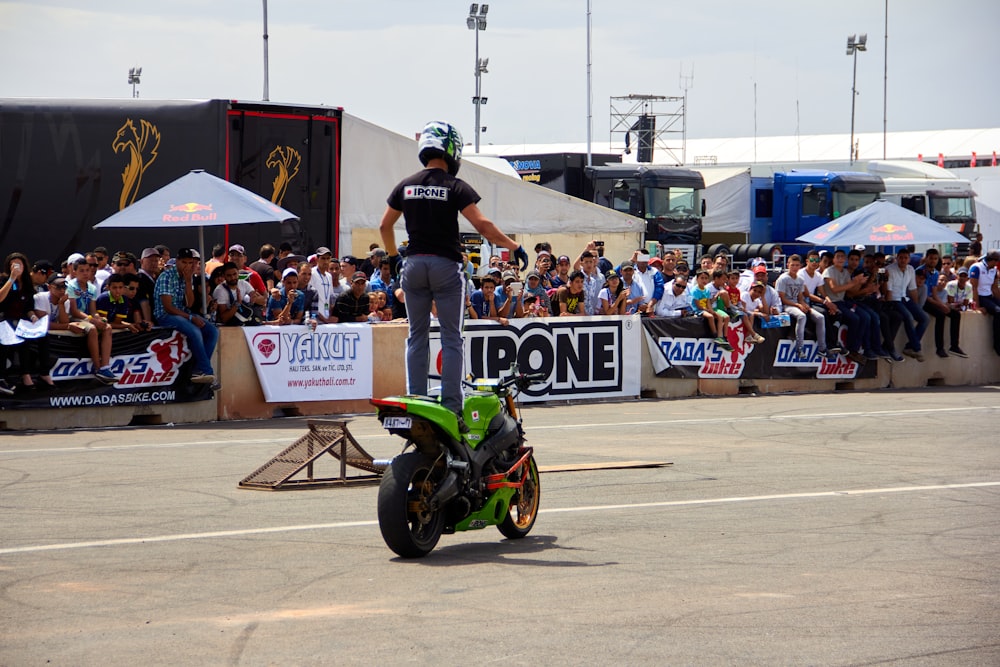 a man riding a motorcycle on top of a race track