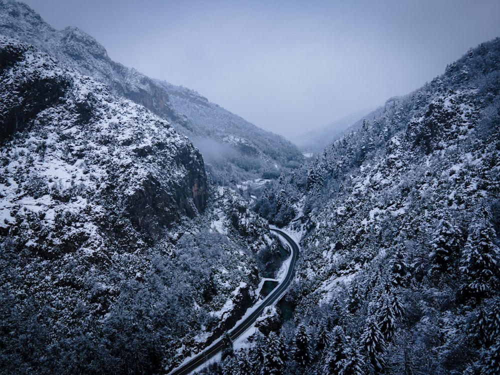 a snowy mountain with a road winding through it