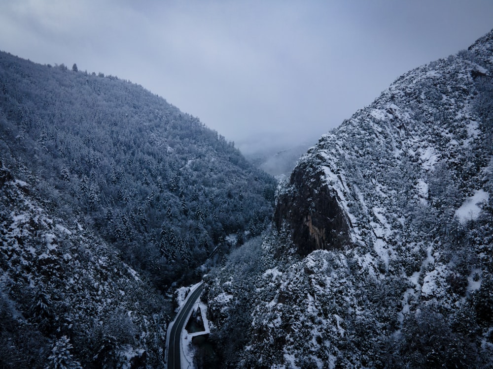 a snowy mountain with a road going through it