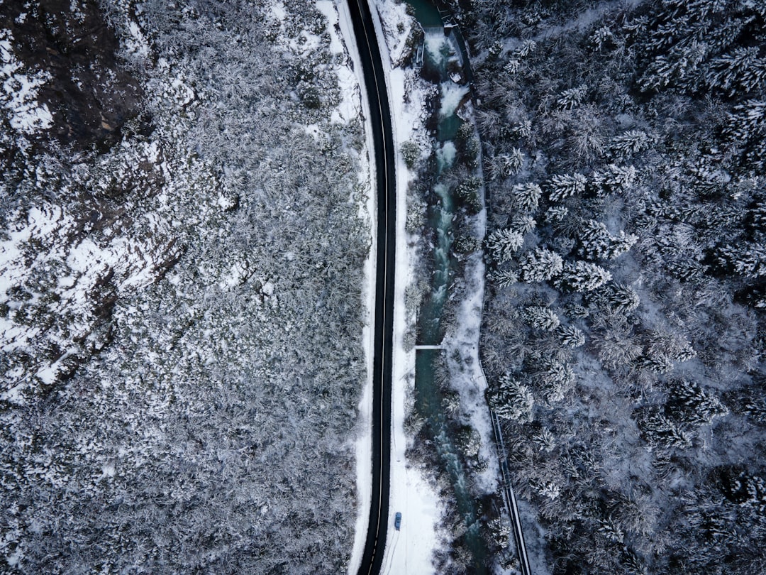 an aerial view of a snow covered road,