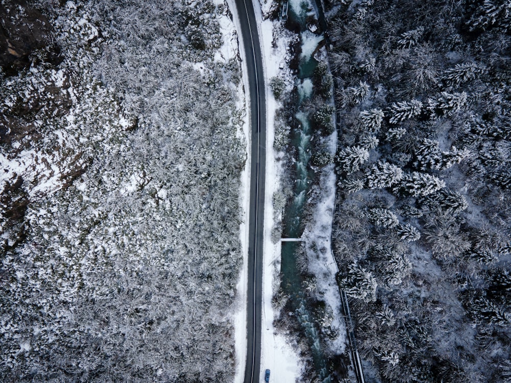 an aerial view of a road surrounded by snow