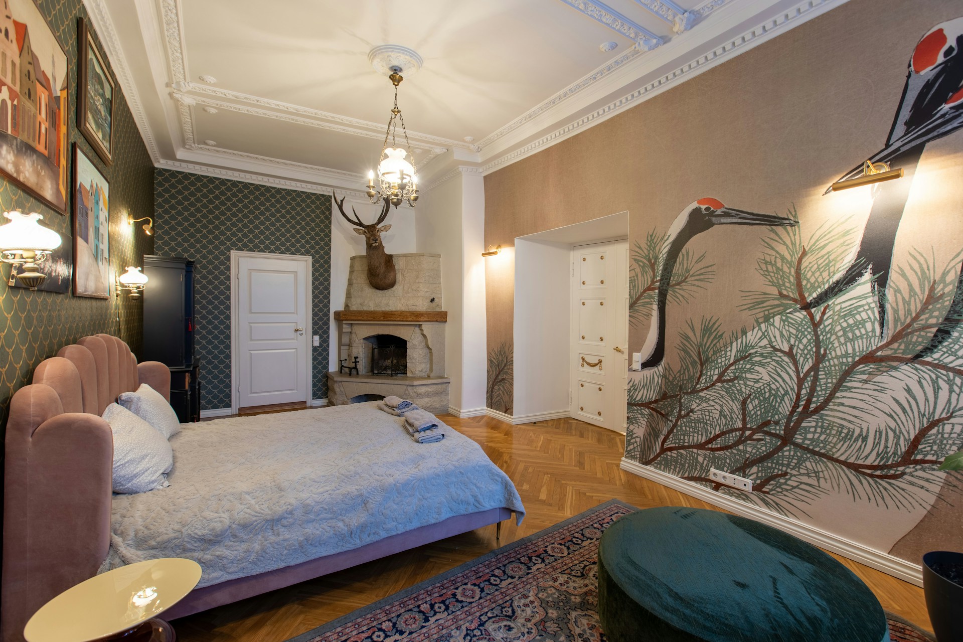 a bed room with a neatly made bed and a painting on the wall