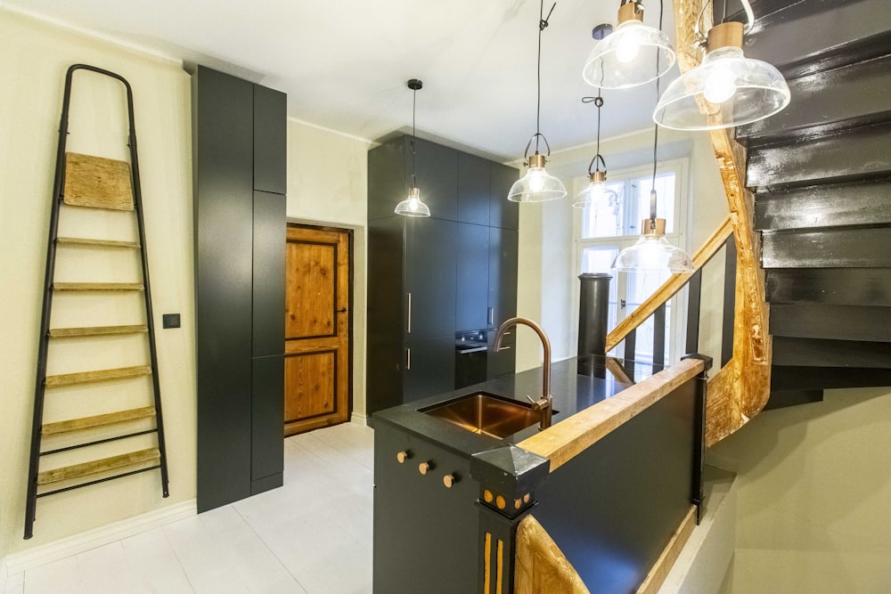 a kitchen with a sink and a ladder