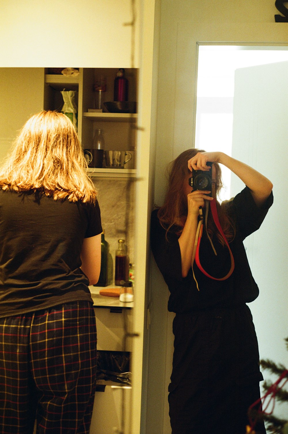 a woman taking a picture of herself in a mirror