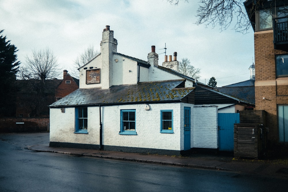 a small white building with a blue door