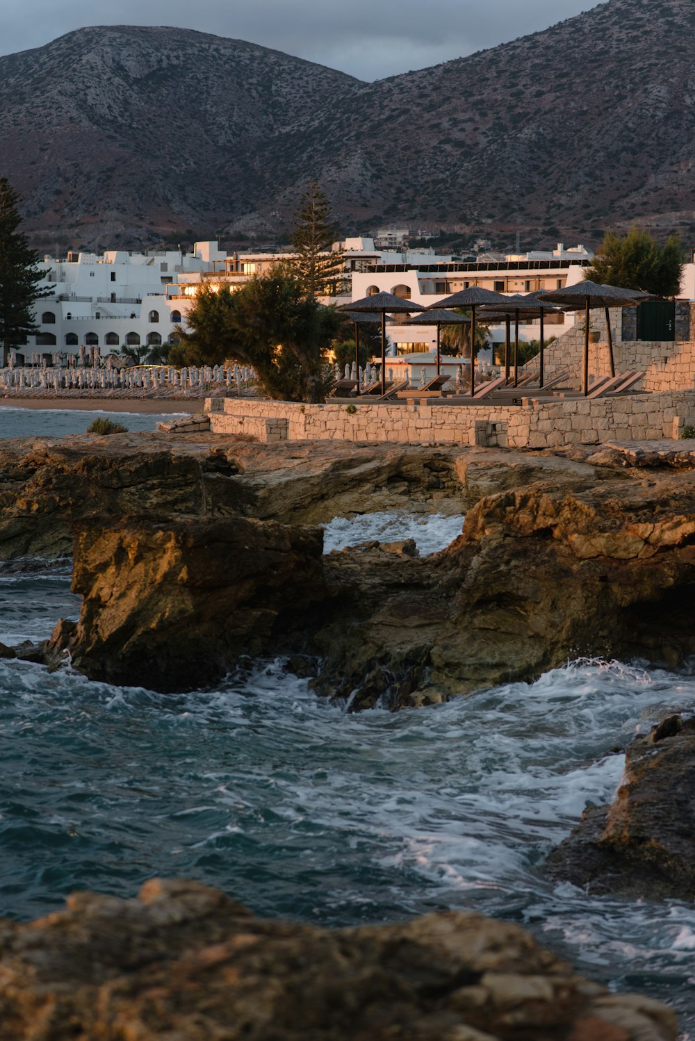 a large body of water next to a rocky shore