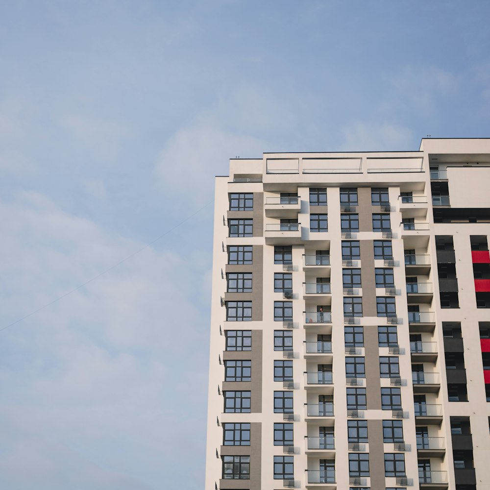 a very tall building with a red and white flag on it