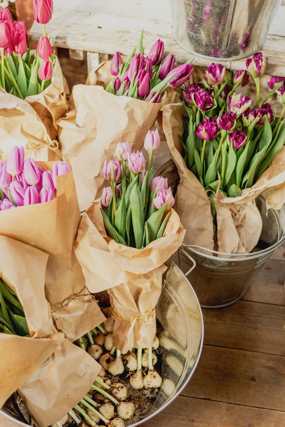 a couple of buckets filled with lots of flowers