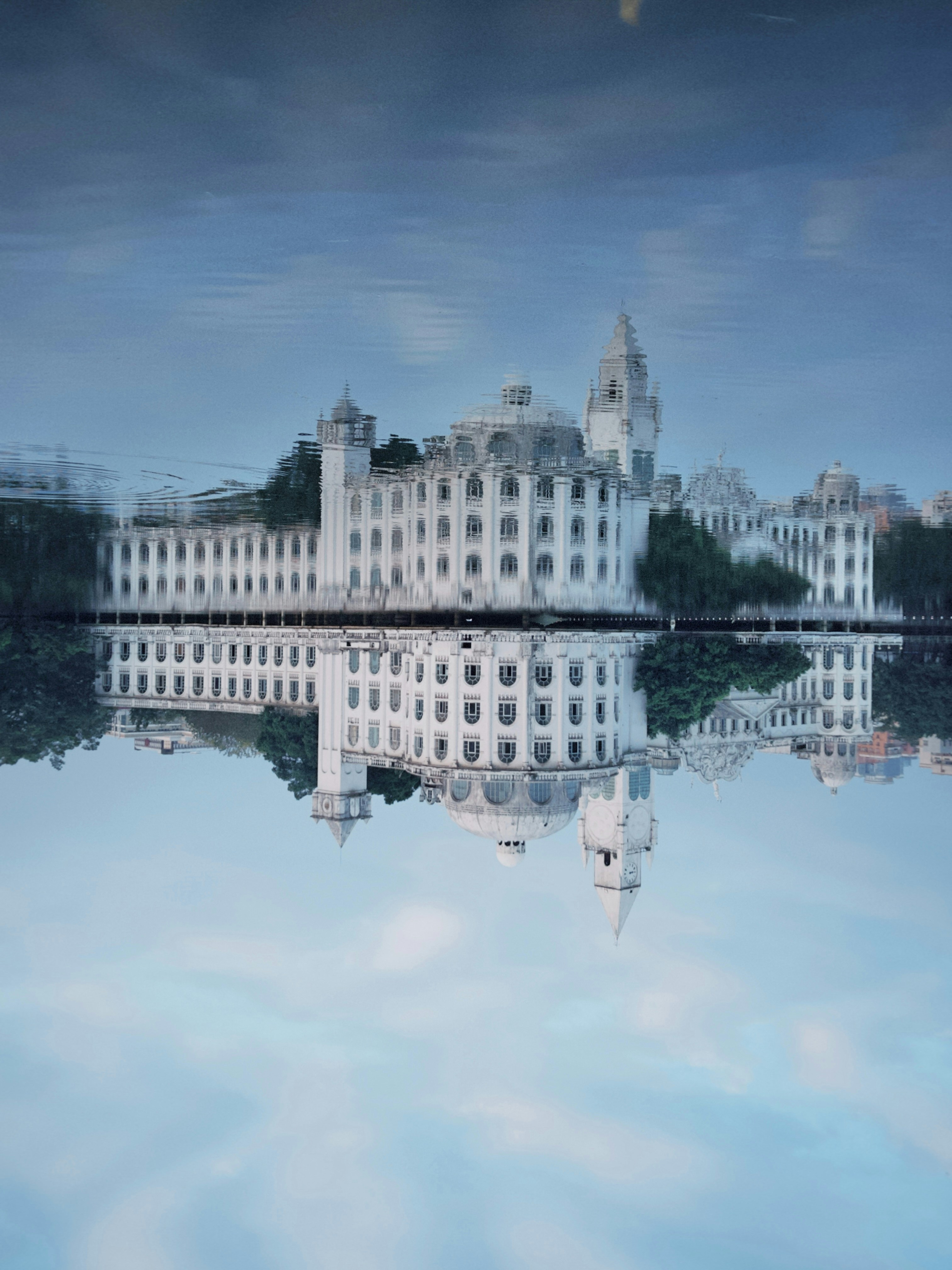 a large white building sitting on top of a lake