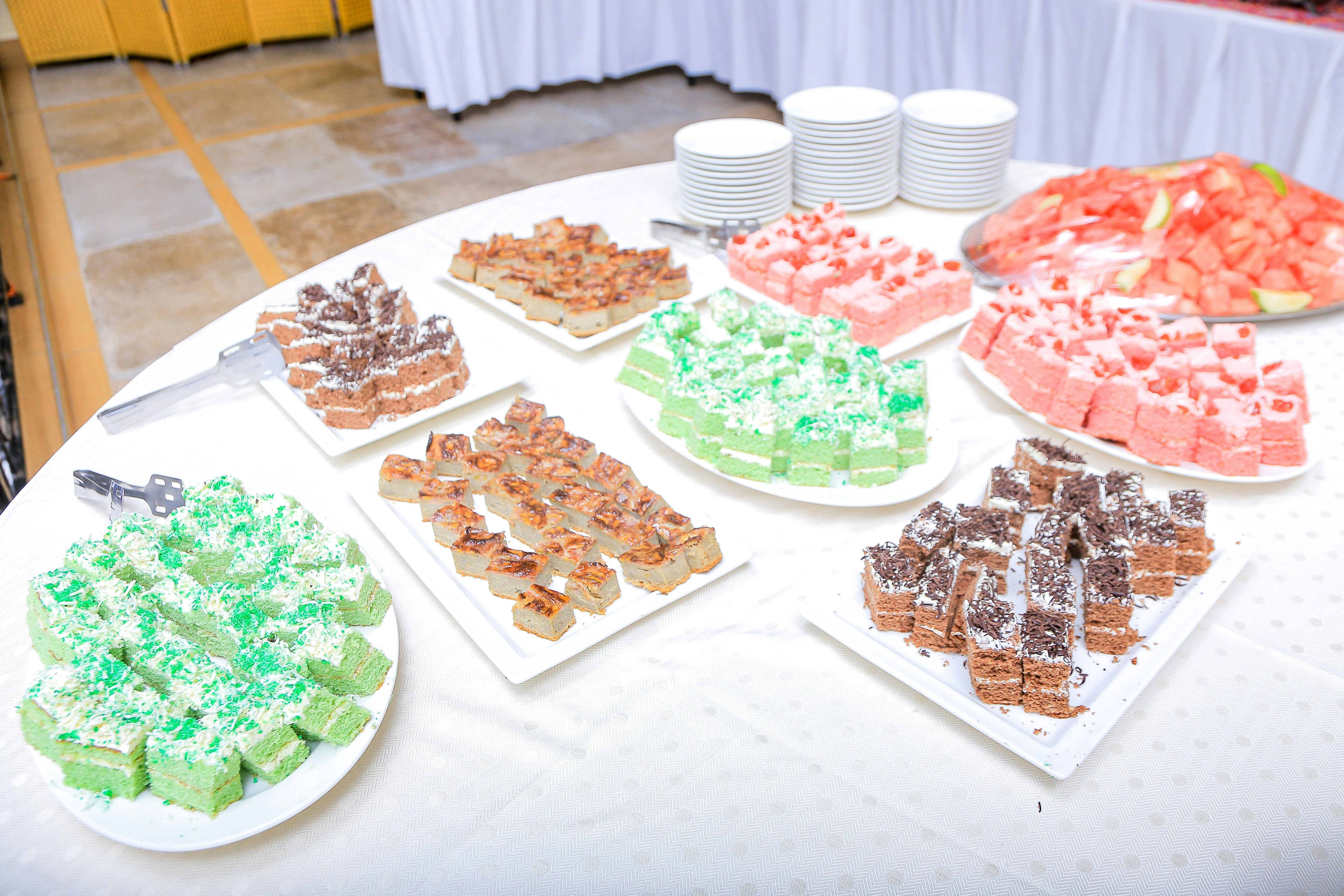 colorful bake sale table with cookies and cakes - youth group fundraiser ideas