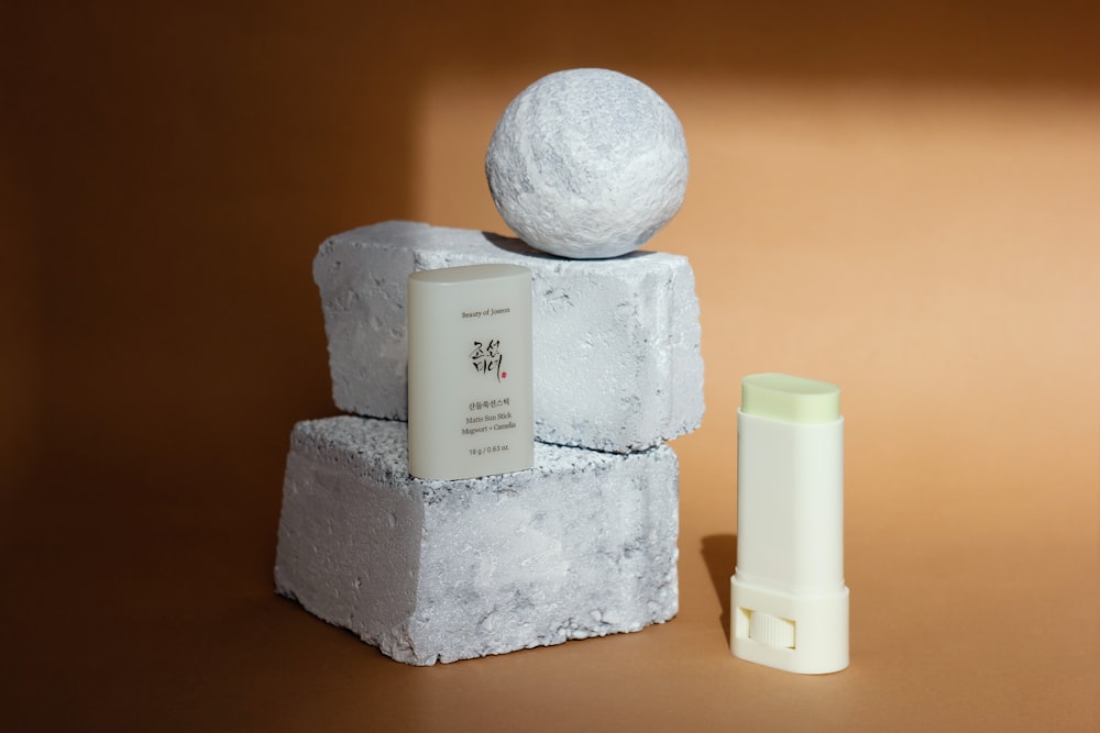 a white object sitting on top of a block of cement