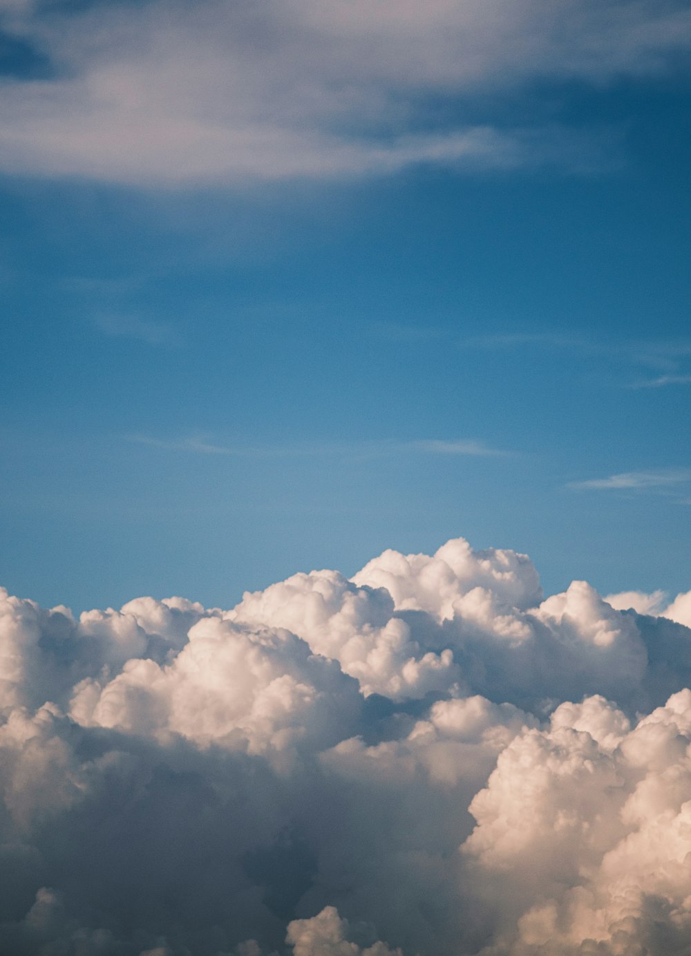 a plane is flying high above the clouds