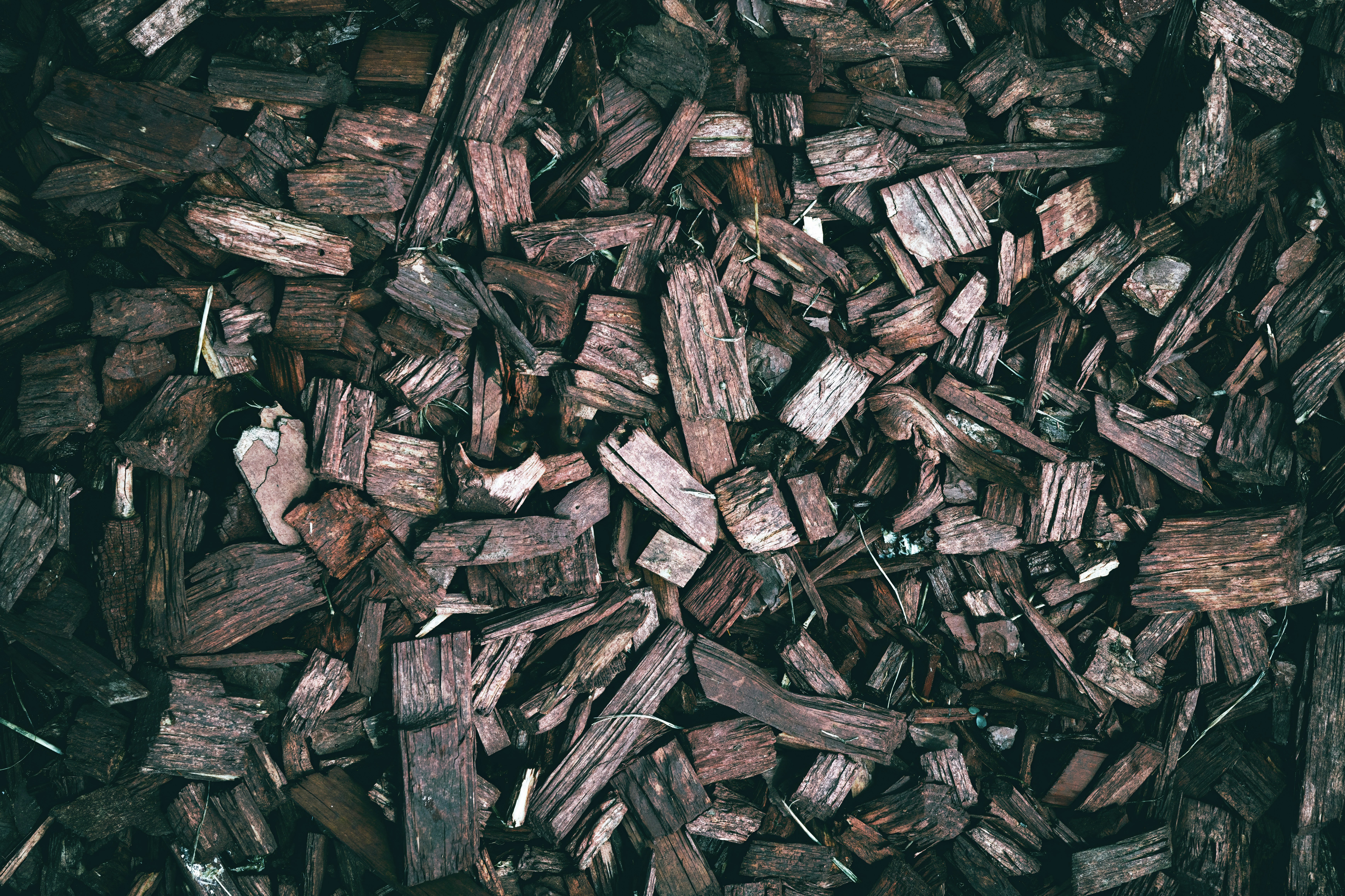 a pile of wood chips sitting on top of a pile of wood