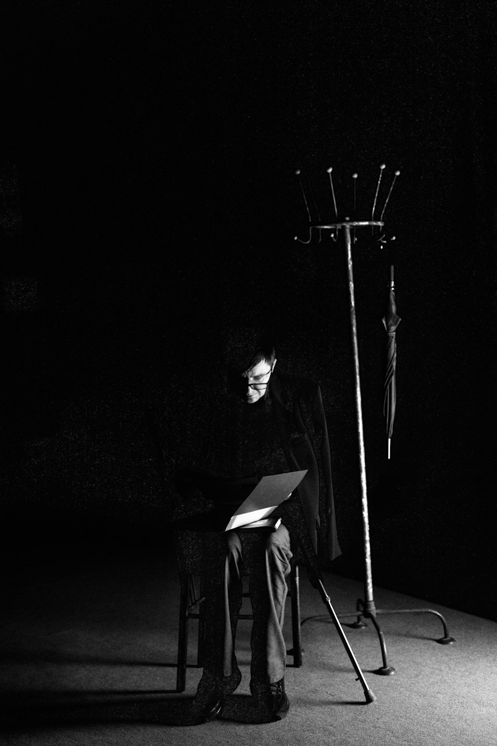 a man sitting in a chair in a dark room