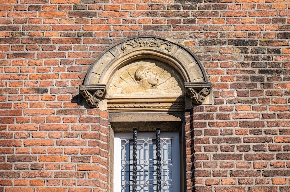 a brick building with a window and iron bars