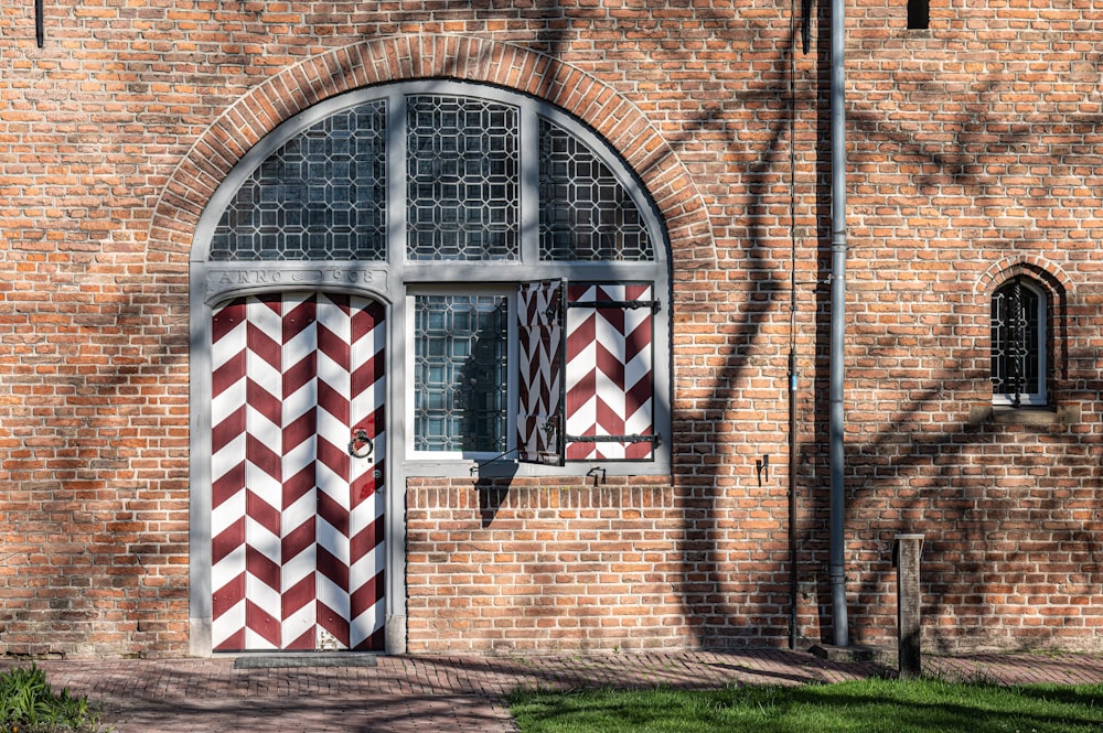 a brick building with a red and white striped door