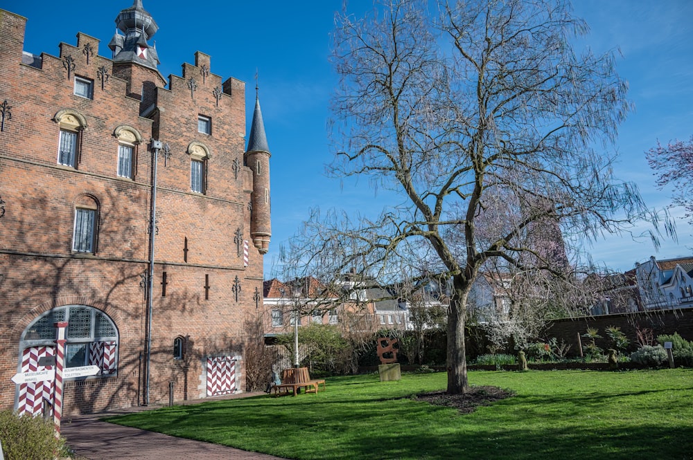 a large brick building with a tree in front of it