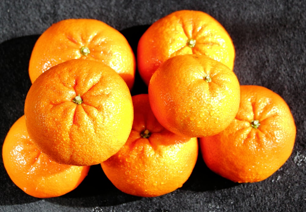 a pile of oranges sitting on top of a table