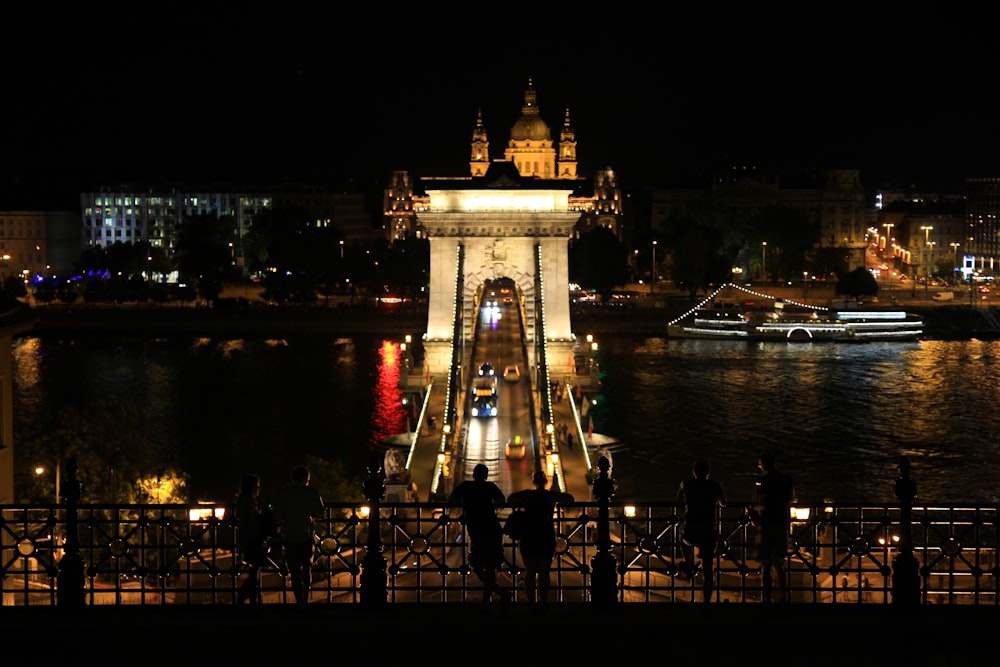 a group of people standing on top of a bridge