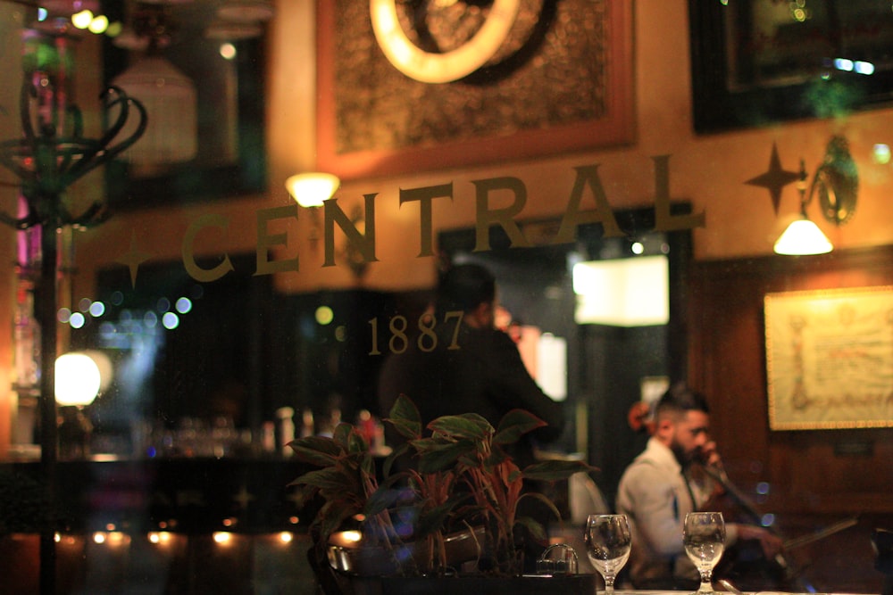 a man sitting at a table in front of a restaurant