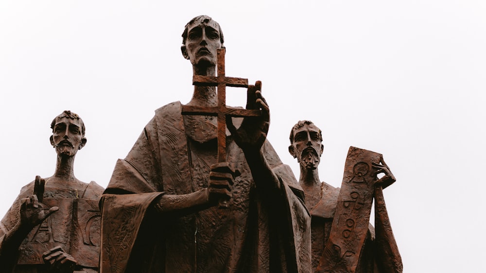 a statue of a man holding a cross