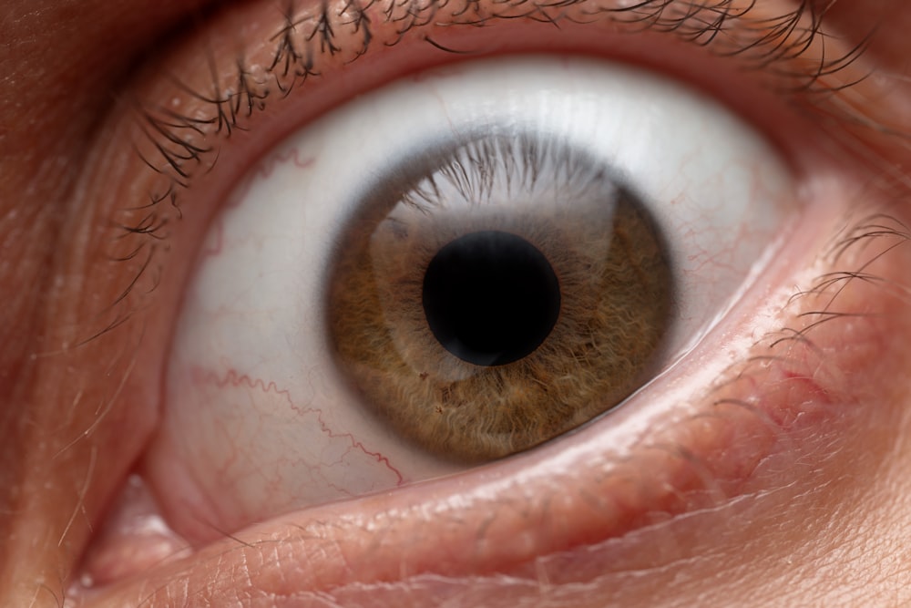 a close up of a person's brown eye