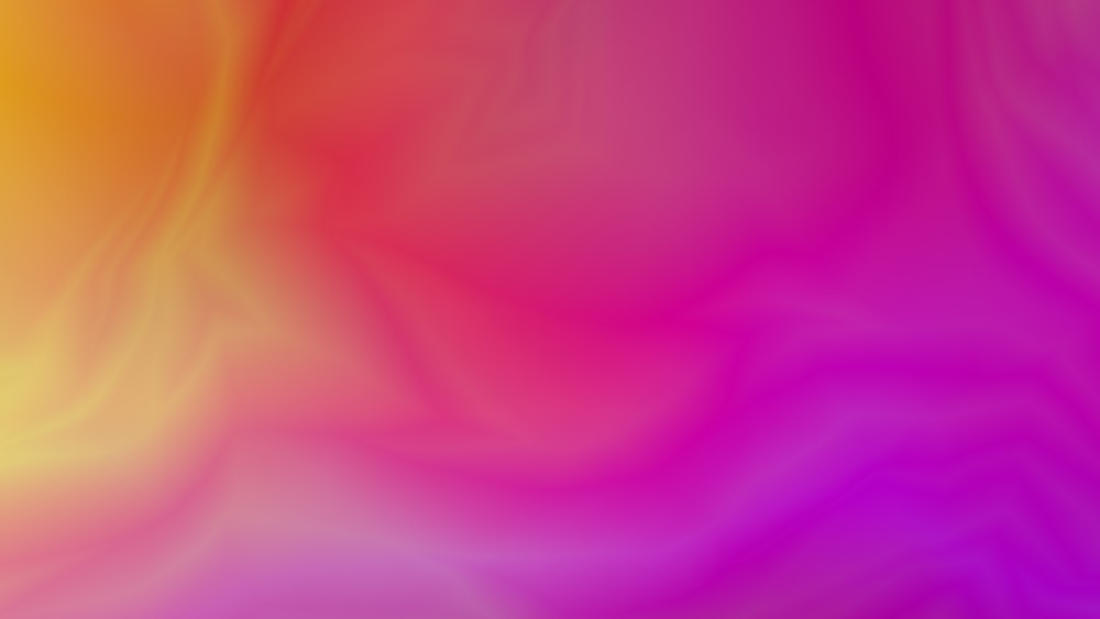 a blurry image of a pink and yellow background