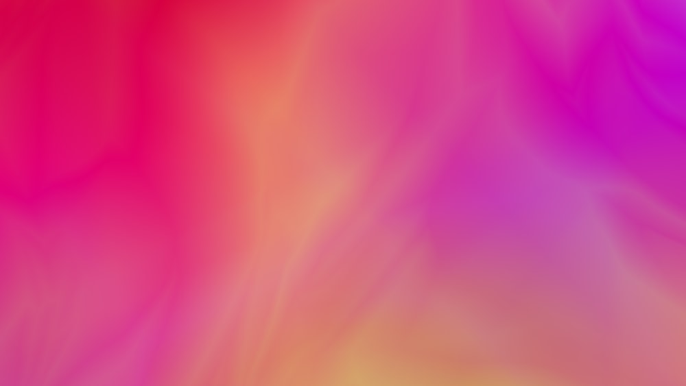 a blurry image of a pink and yellow background