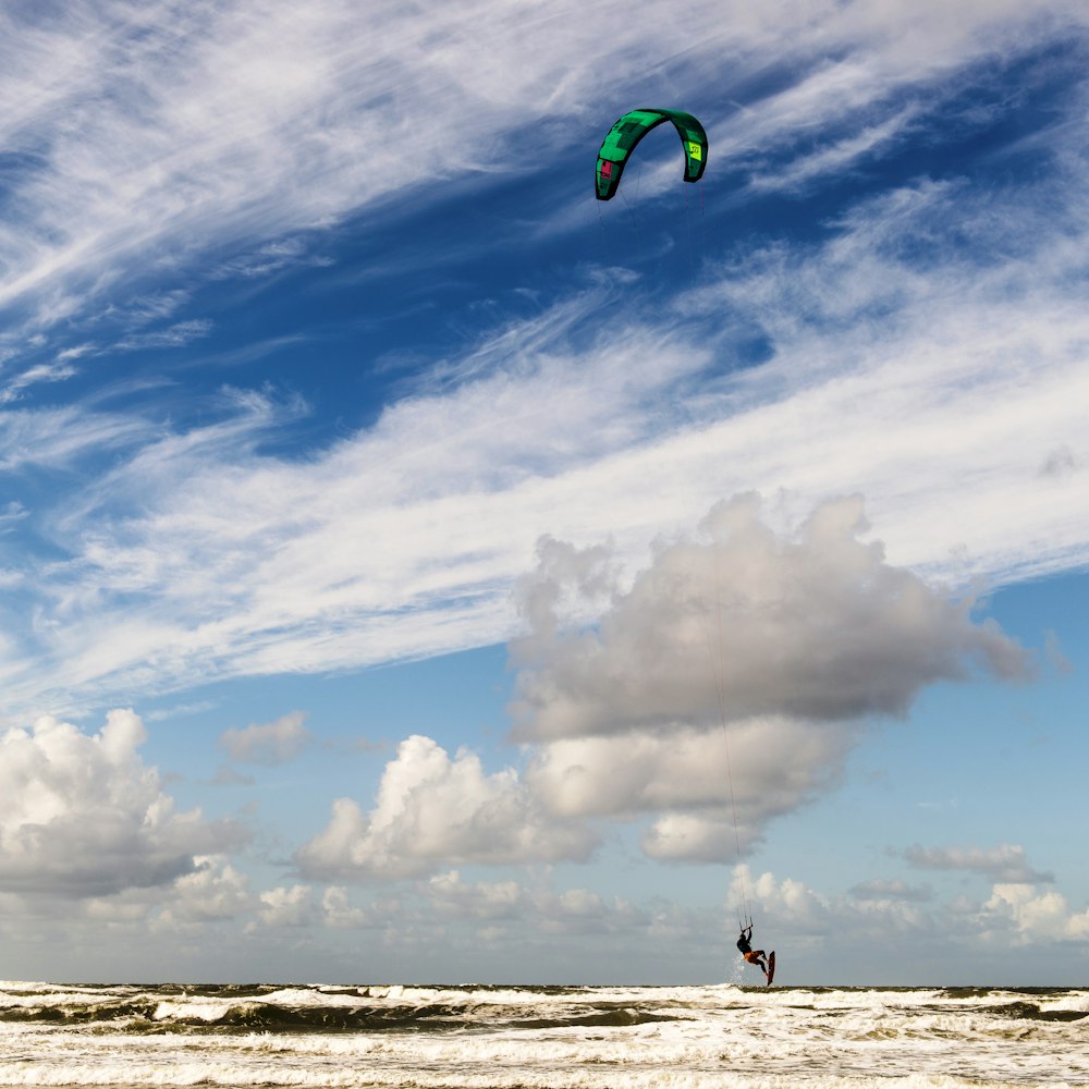 a person para sailing in the ocean on a cloudy day