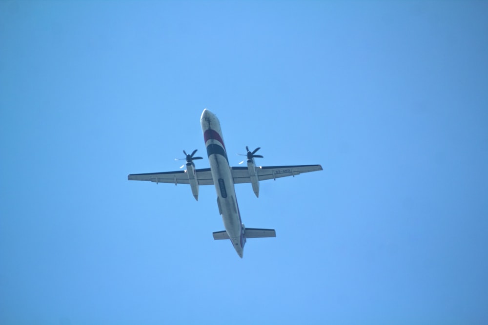 an airplane is flying in the blue sky